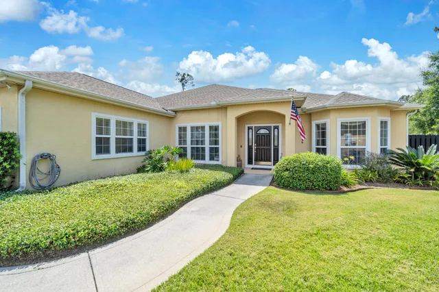 a aerial view of a house with a yard and garden