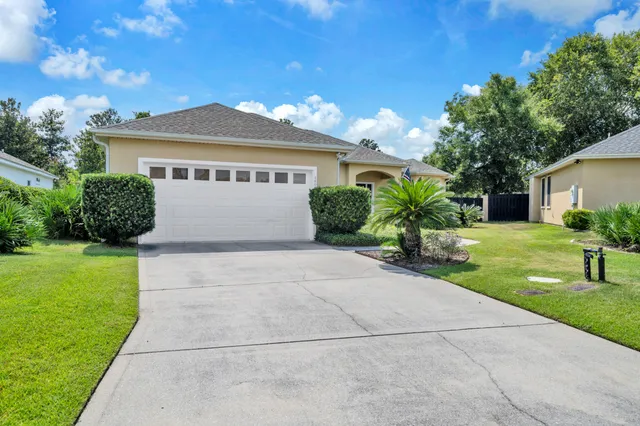 an aerial view of a house with swimming pool and garden
