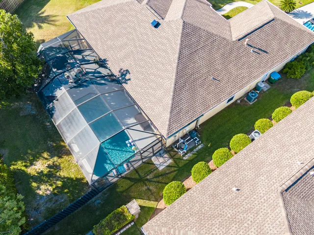 an aerial view of a house with a yard basket ball court and outdoor seating
