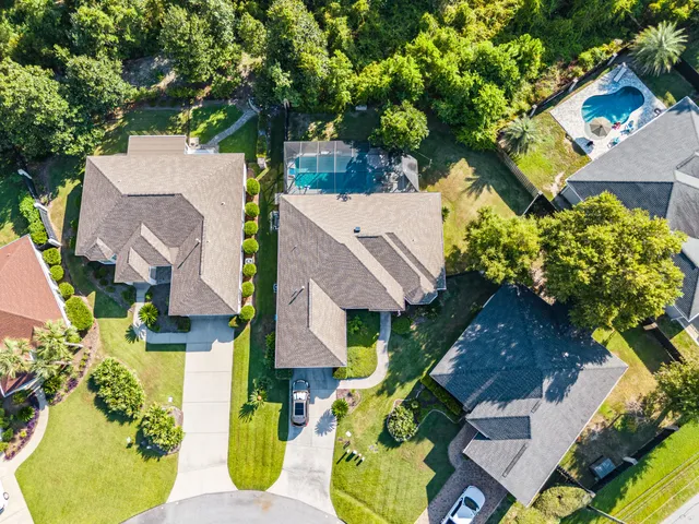 an aerial view of residential houses with outdoor space