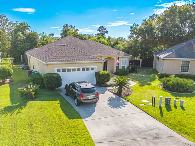 a front view of house with yard and outdoor seating