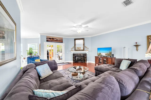 a living room with furniture fireplace and a large window