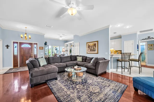 a living room with furniture and wooden floor