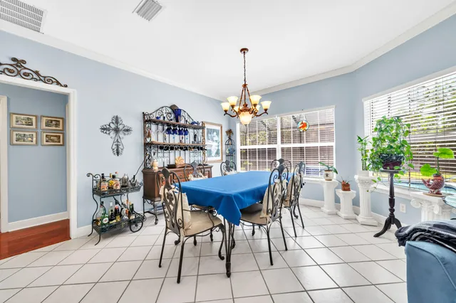 a view of a dining room with furniture and a chandelier
