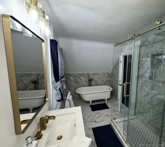 a bathroom with a sink toilet and shower
