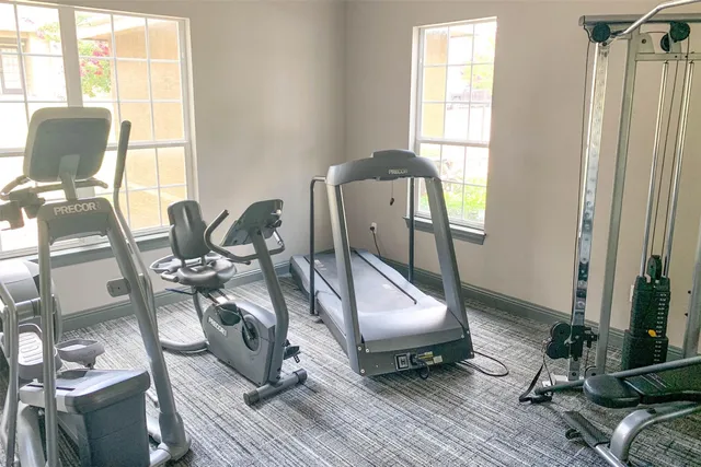a living room with furniture a wooden floor and a large window