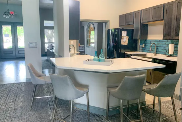 a dining table with chairs and window