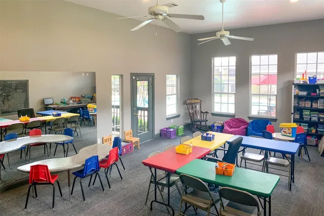 a room with furniture pool table and windows