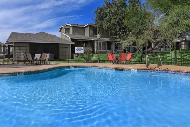 a view of house with swimming pool and porch