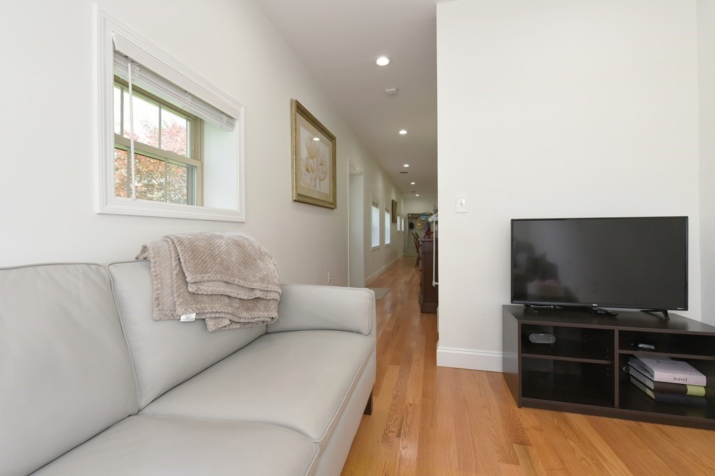 31 Elm Street Upton, MA 01568 - Photo 11 of 33 a living room with furniture and a flat screen tv