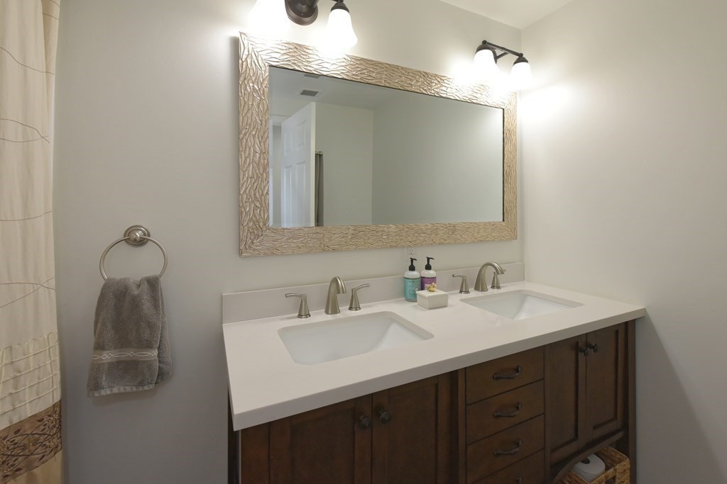 31 Elm Street Upton, MA 01568 - Photo 16 of 33 a bathroom with a sink and a mirror
