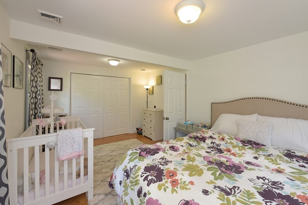 31 Elm Street Upton, MA 01568 - Photo 21 of 33 a bedroom with a bed and a mirror