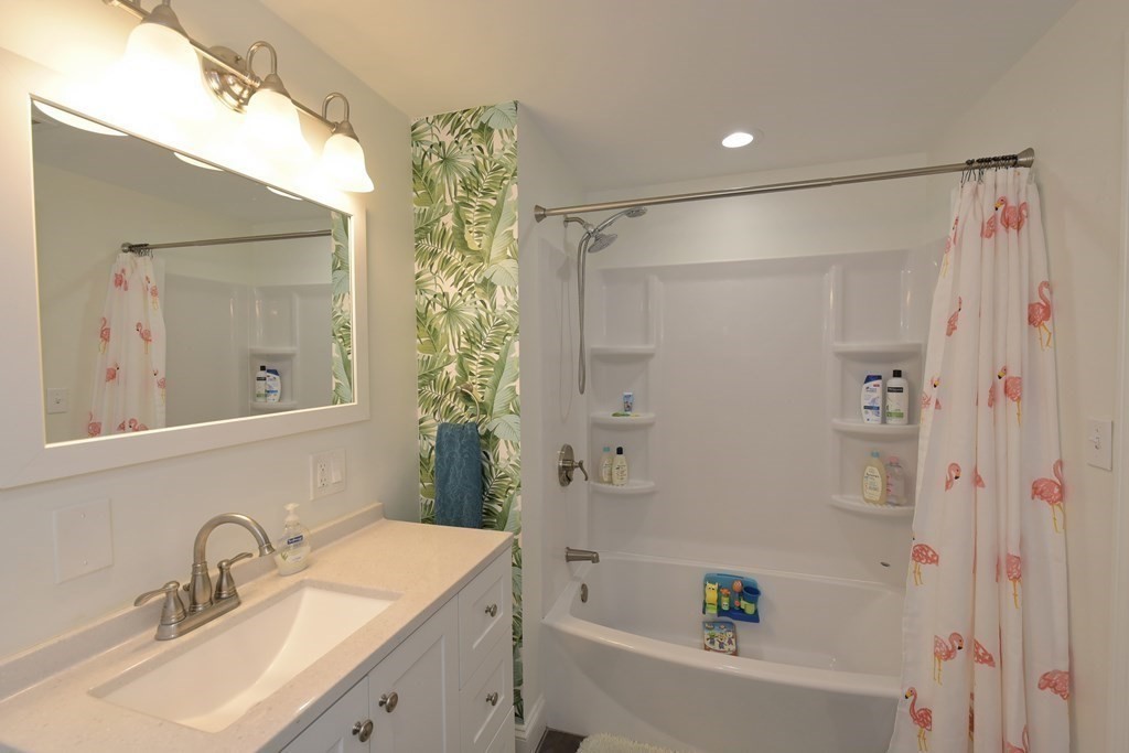 31 Elm Street Upton, MA 01568 - Photo 24 of 33 a bathroom with a sink mirror shower and bathtub