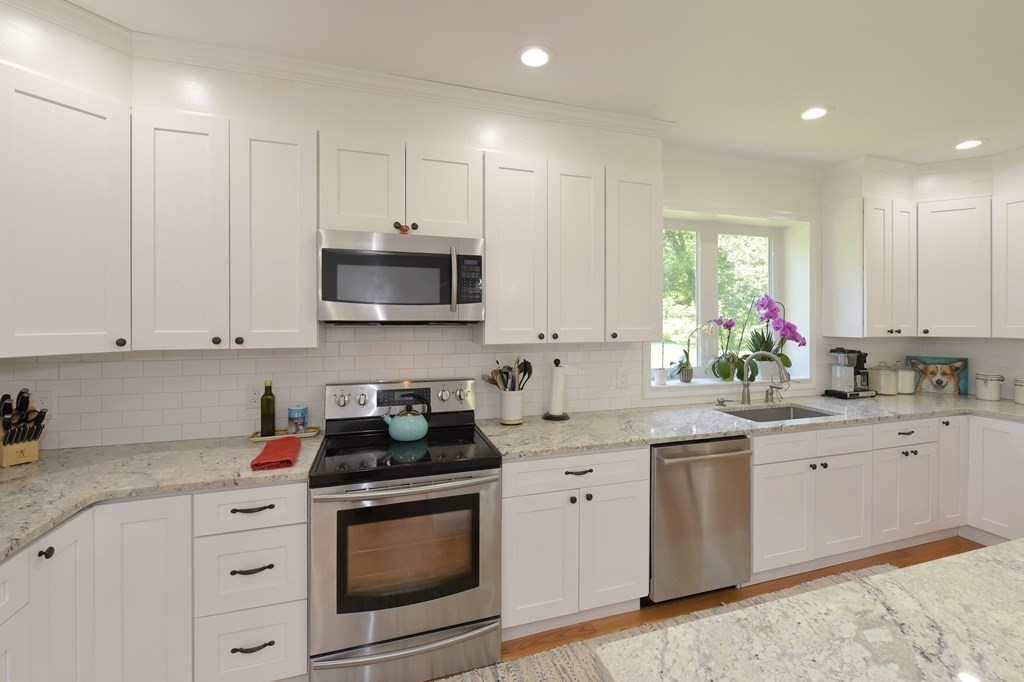 31 Elm Street Upton, MA 01568 - Photo 5 of 33 a kitchen with stainless steel appliances granite countertop white cabinets a sink and dishwasher
