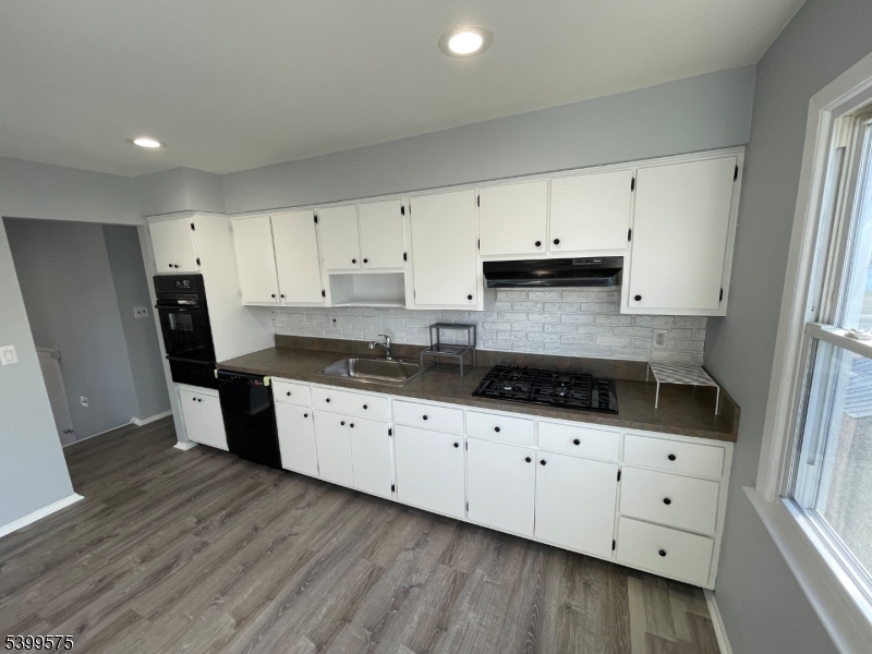 57 Greenbrook Road Middlesex, NJ 08846 - Photo 7 of 14 a kitchen with granite countertop a sink a stove a refrigerator and cabinets