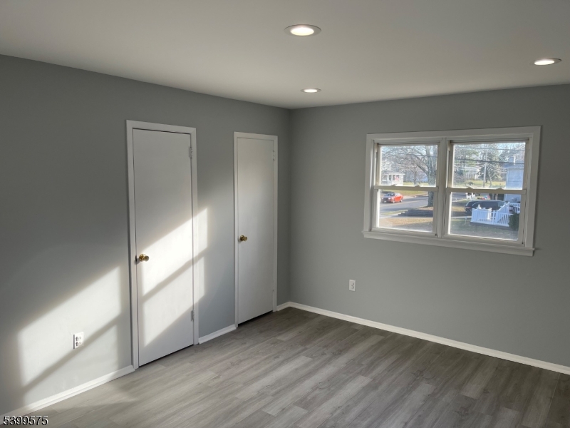 57 Greenbrook Road Middlesex, NJ 08846 - Photo 9 of 14 an empty room with wooden floor and windows