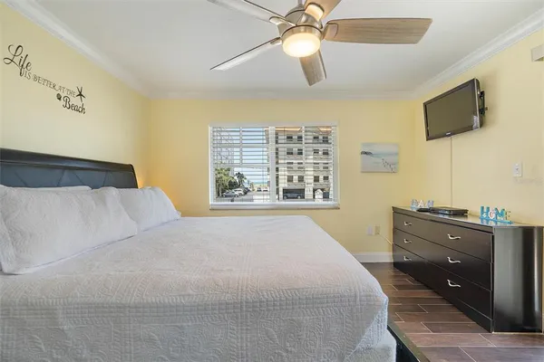 a bedroom with a large bed and flat tv