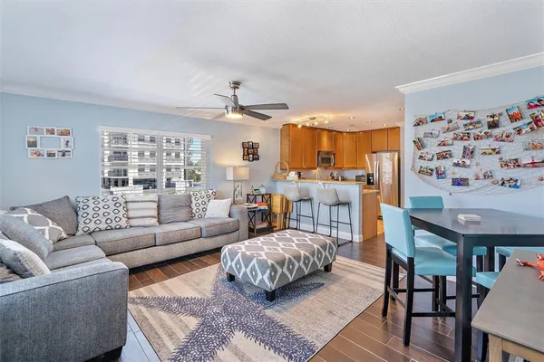 a living room with furniture and a view of kitchen
