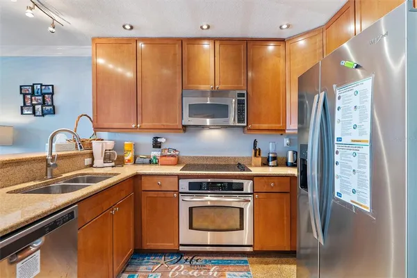a kitchen with a sink stove and refrigerator