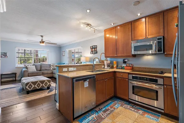 a kitchen with stainless steel appliances granite countertop a stove and cabinets
