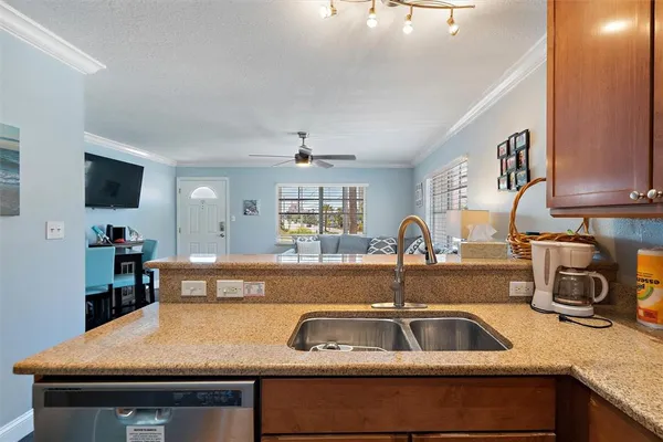 a kitchen with a sink and a stove top oven