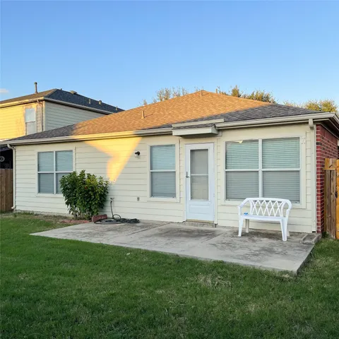 a backyard of a house with table and chairs