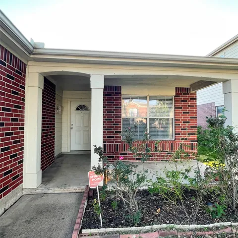 a view of a porch with a floor to ceiling window and potted plants