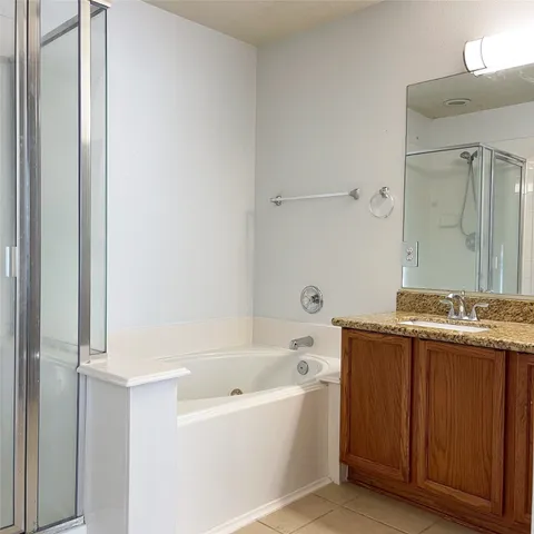 a bathroom with a granite countertop sink a toilet and shower