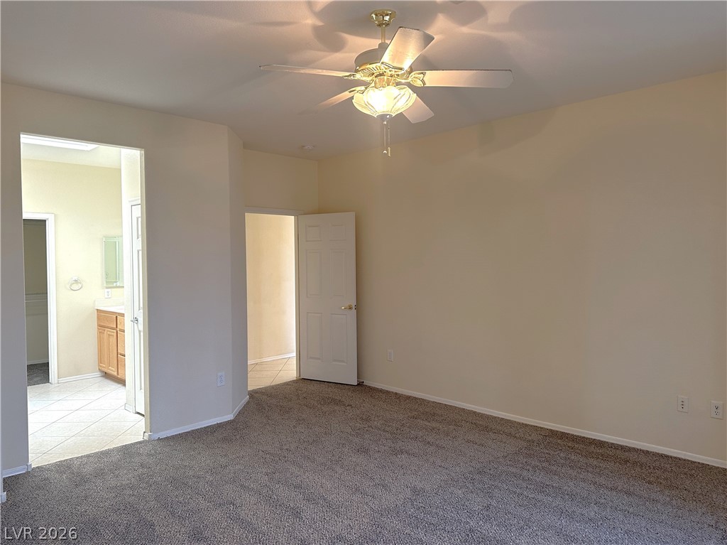 3034 Canal Walk Road Henderson, NV 89052 - Photo 10 of 24 This spacious primary bedroom offers comfort and a private attached bathroom.