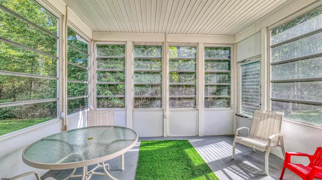 a view of a room that has a bed and glass window