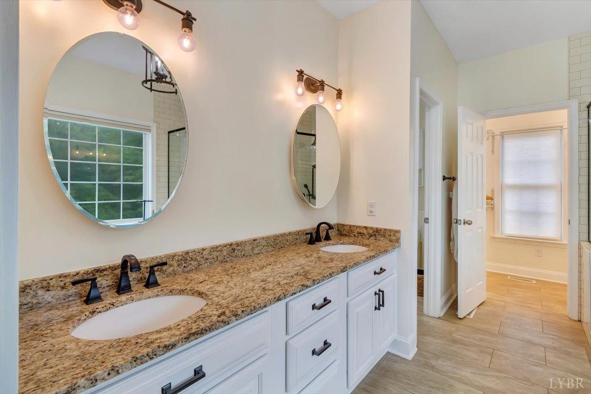 911 Police Tower Road Appomattox, VA 24522 - Photo 17 of 55 a bathroom with a granite countertop sink and a mirror