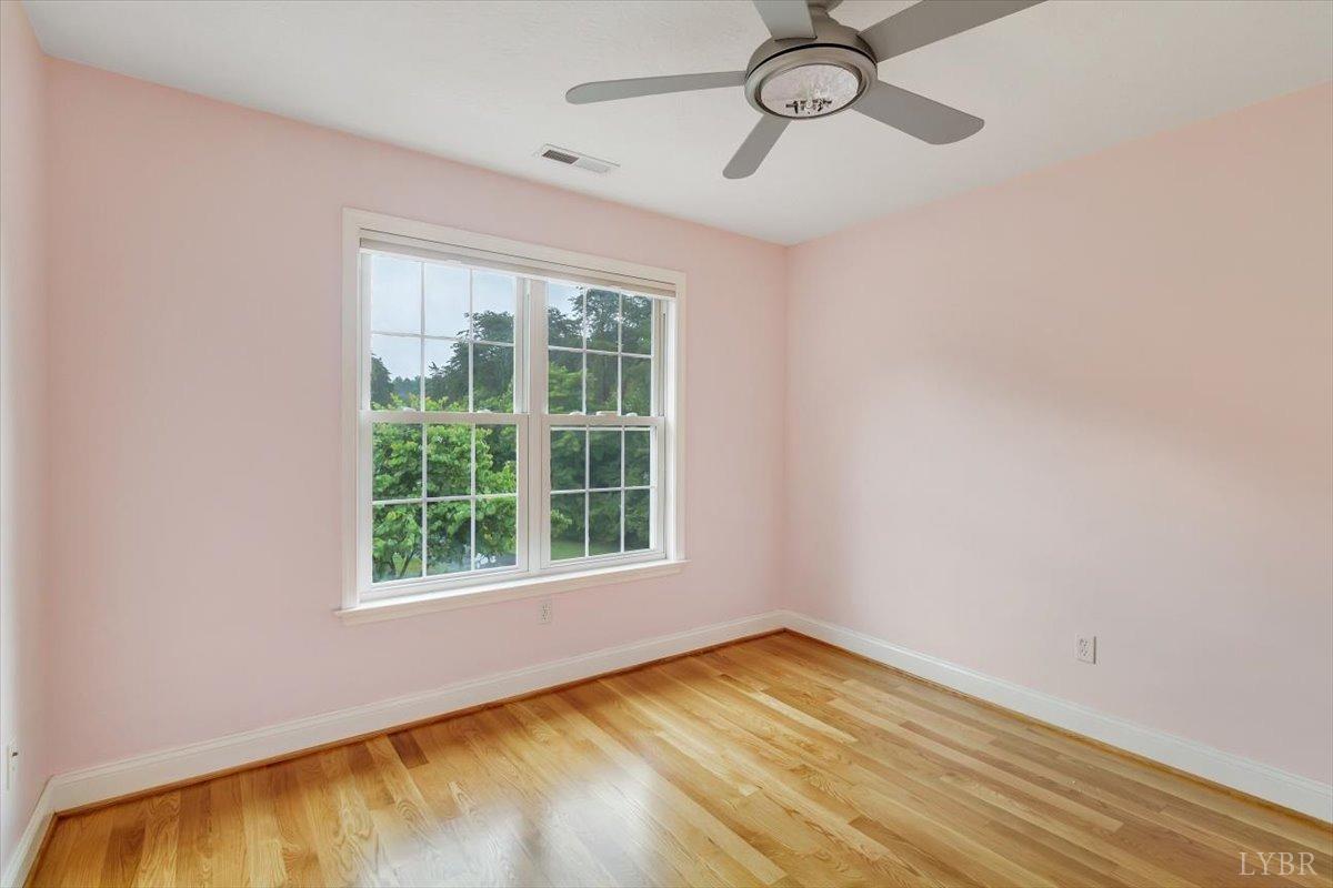 911 Police Tower Road Appomattox, VA 24522 - Photo 23 of 55 a view of empty room with wooden floor and fan