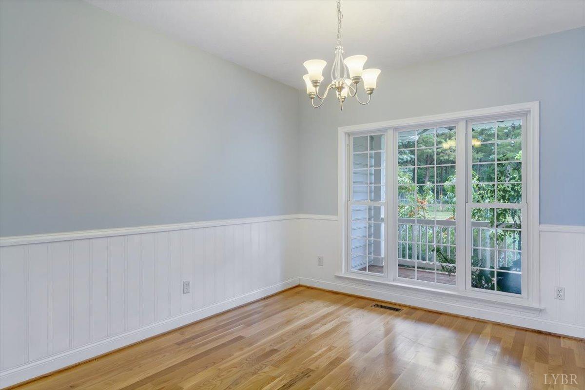 911 Police Tower Road Appomattox, VA 24522 - Photo 5 of 55 a view of empty room with wooden floor and fan