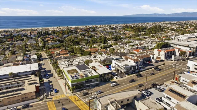 an aerial view of a building with parking