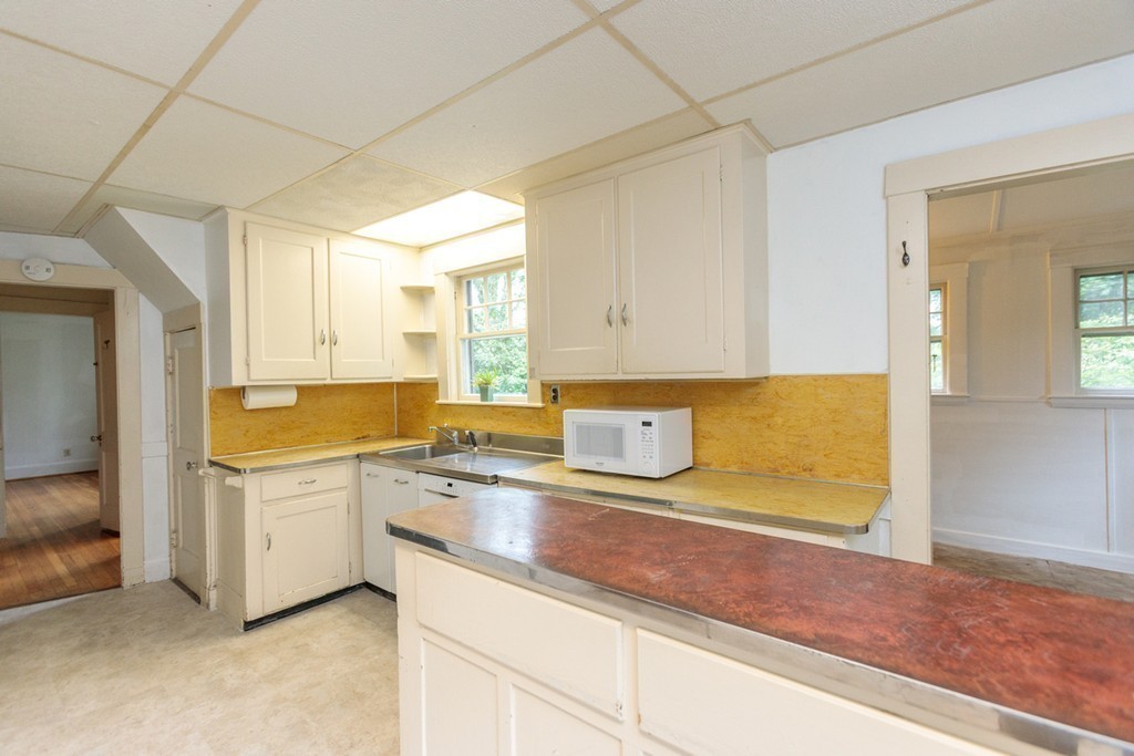 271 Glen Road Weston, MA 02493 - Photo 9 of 21 a kitchen with a sink stove and cabinets