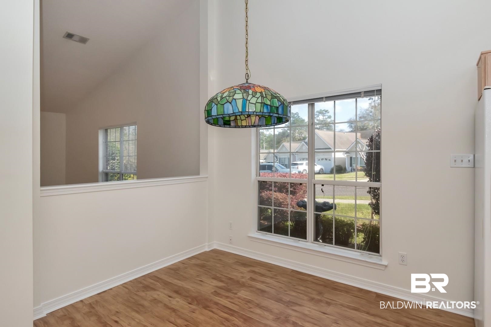 672 Spring Lake Drive East Mobile, AL 36695 - Photo 20 of 26 Unfurnished dining area with plenty of natural light, visible vents, and wood finished floors