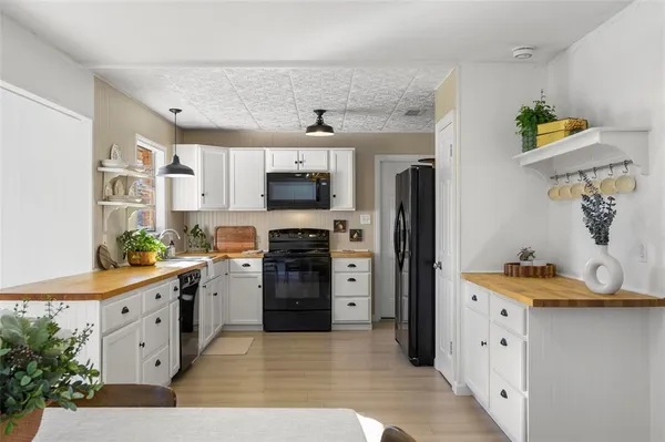a large white kitchen with cabinets and stainless steel appliances
