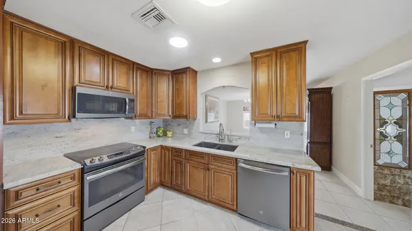 a view of a kitchen with furniture and a ceiling fan