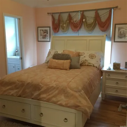 a bedroom with a bed and a cabinet