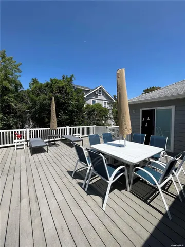 a view of a roof deck with table and chairs