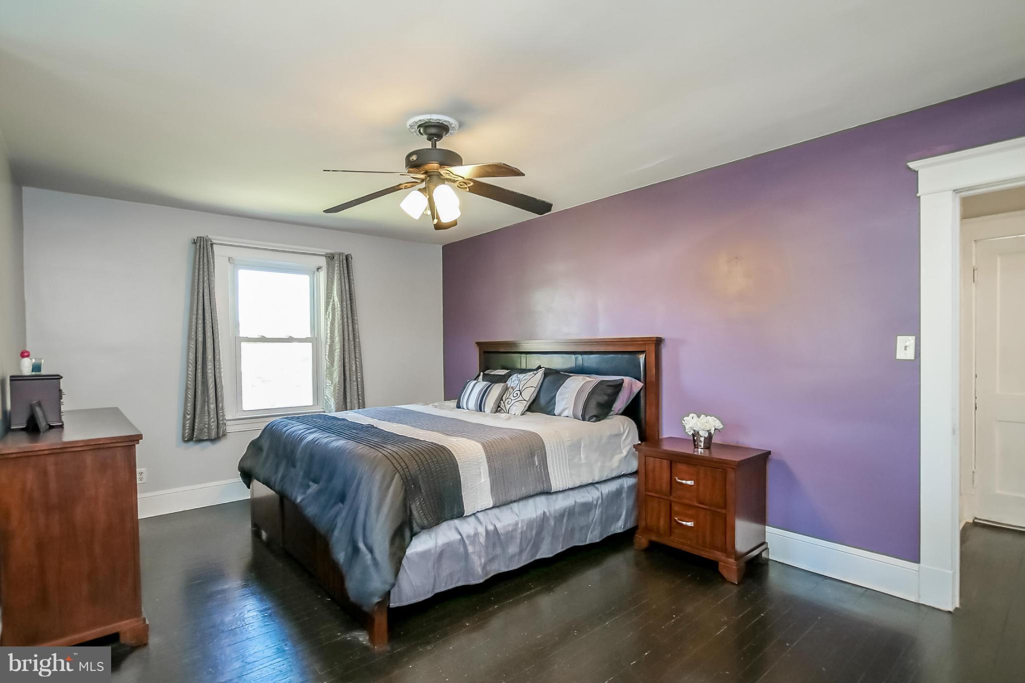 814 Dorchester Road Baltimore, MD 21229 - Photo 17 of 30 a bedroom with a bed and a chandelier