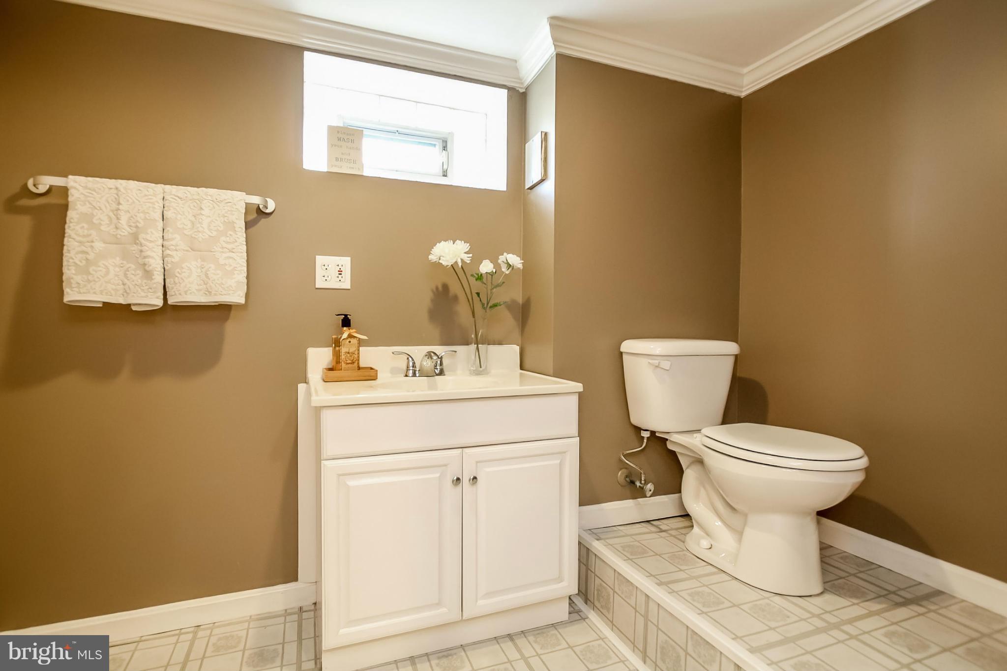 814 Dorchester Road Baltimore, MD 21229 - Photo 24 of 30 a white toilet sitting next to a bathroom sink