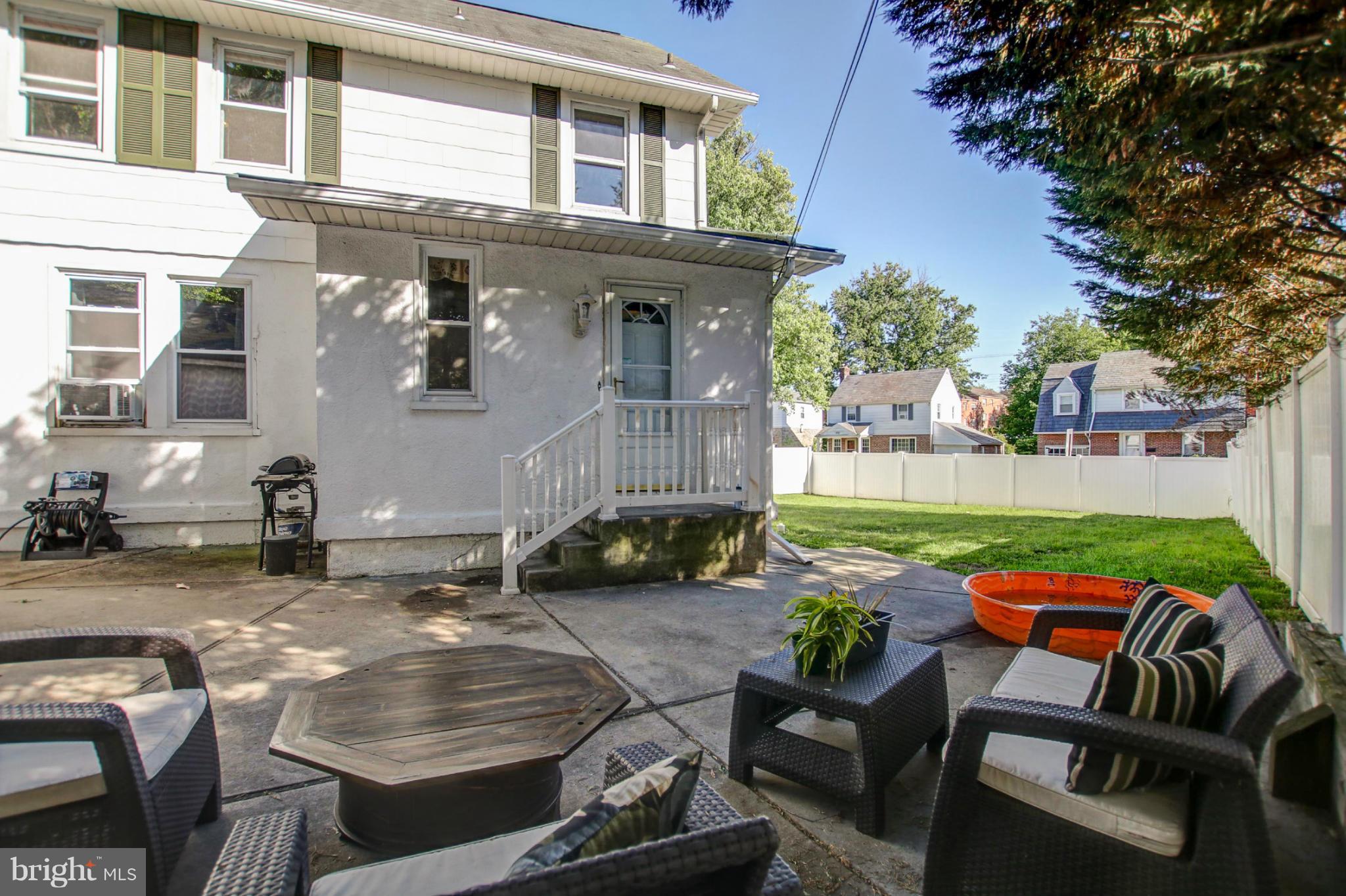 814 Dorchester Road Baltimore, MD 21229 - Photo 27 of 30 a backyard of a house with barbeque oven table and chairs