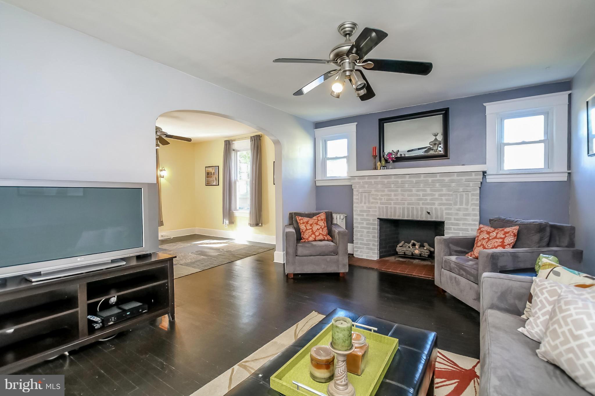 814 Dorchester Road Baltimore, MD 21229 - Photo 5 of 30 a living room with furniture and a fireplace
