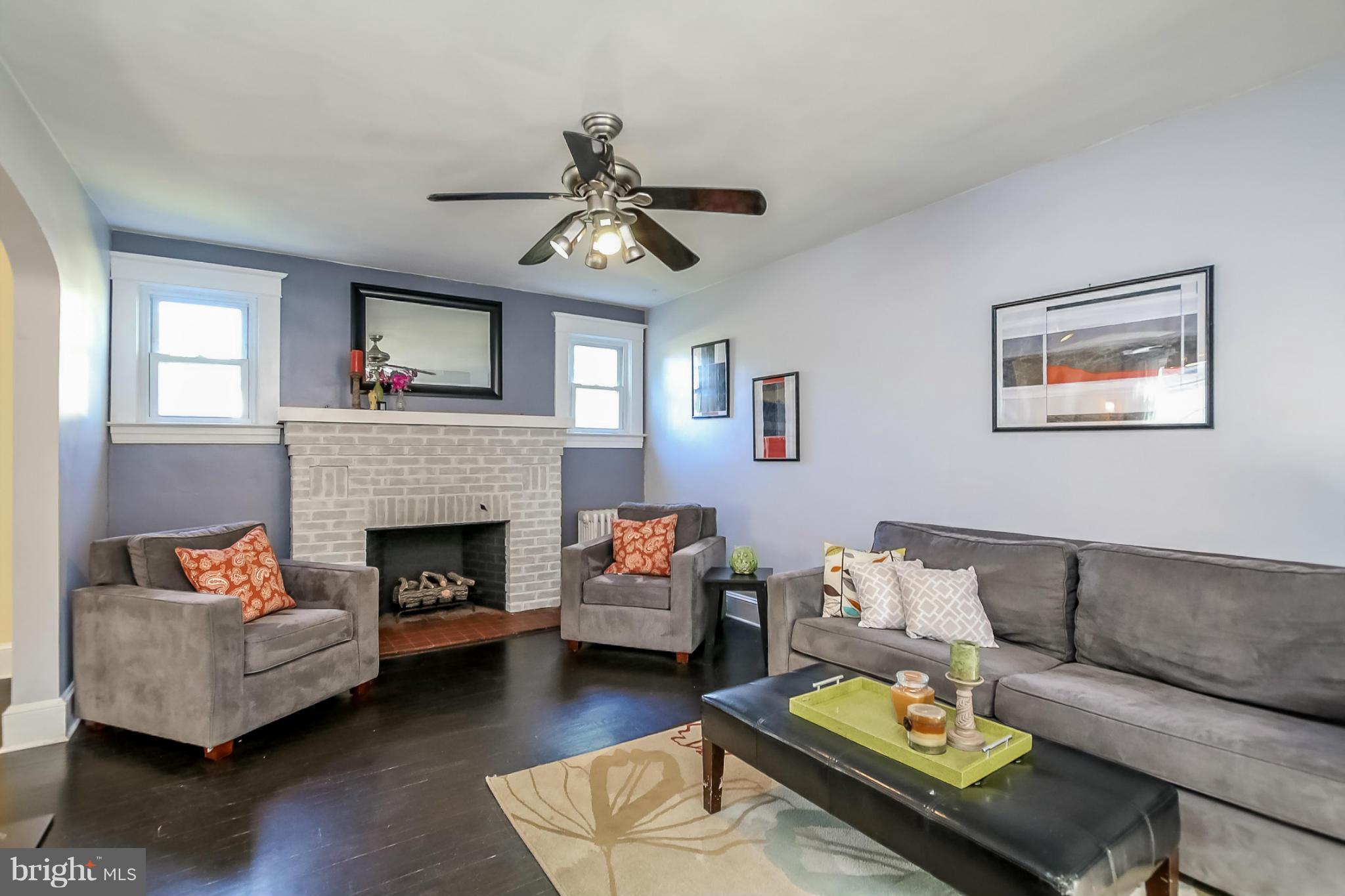 814 Dorchester Road Baltimore, MD 21229 - Photo 6 of 30 a living room with furniture and a fireplace