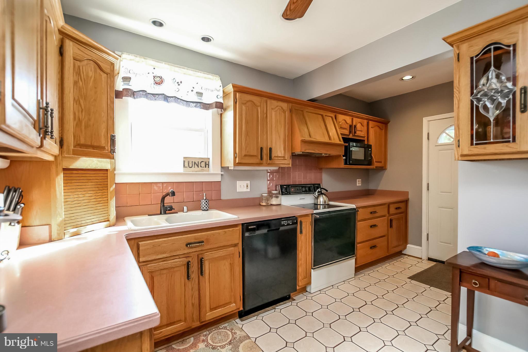 814 Dorchester Road Baltimore, MD 21229 - Photo 10 of 30 a kitchen with a sink stove and cabinets