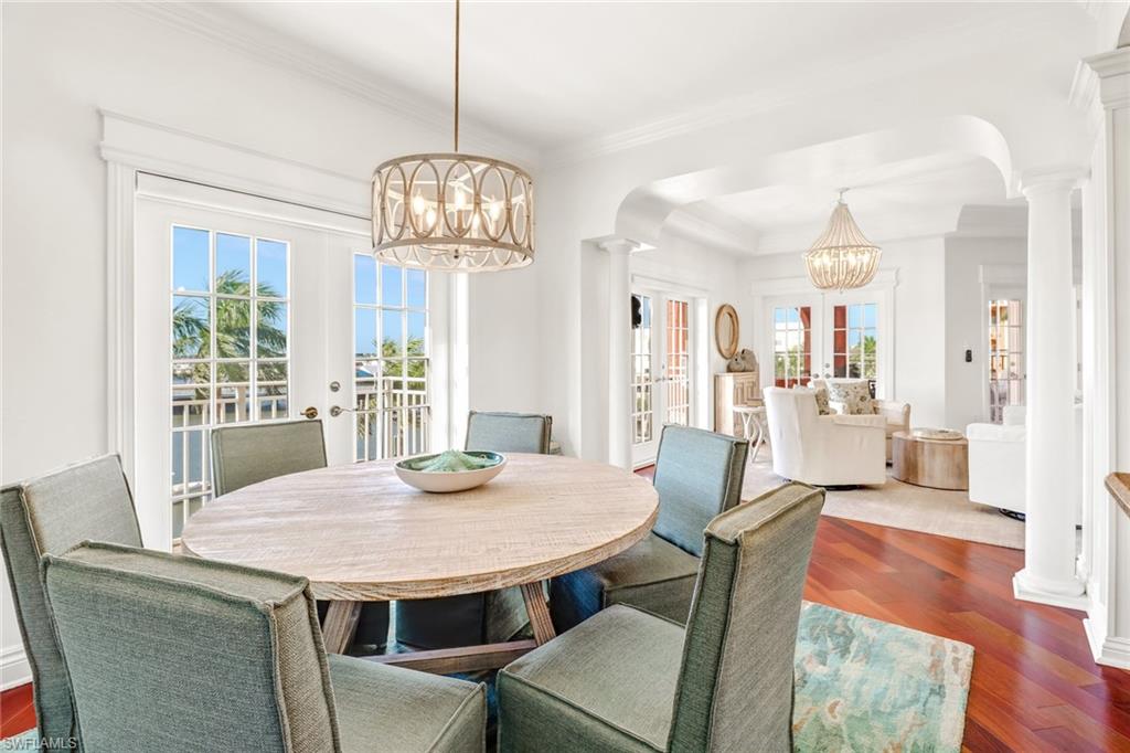 451 Bayfront Place, Unit 5307 Naples, FL 34102 - Photo 13 of 28 a view of a dining room with furniture window and wooden floor
