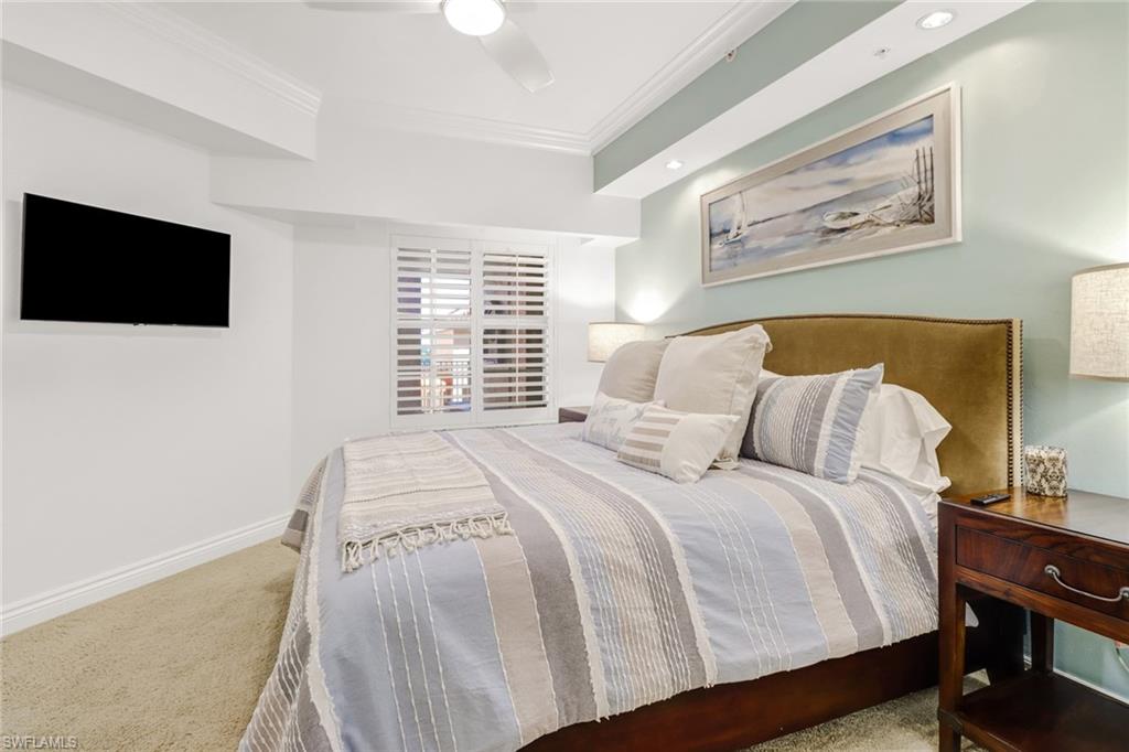 451 Bayfront Place, Unit 5307 Naples, FL 34102 - Photo 18 of 28 a bedroom with a large bed and a tv
