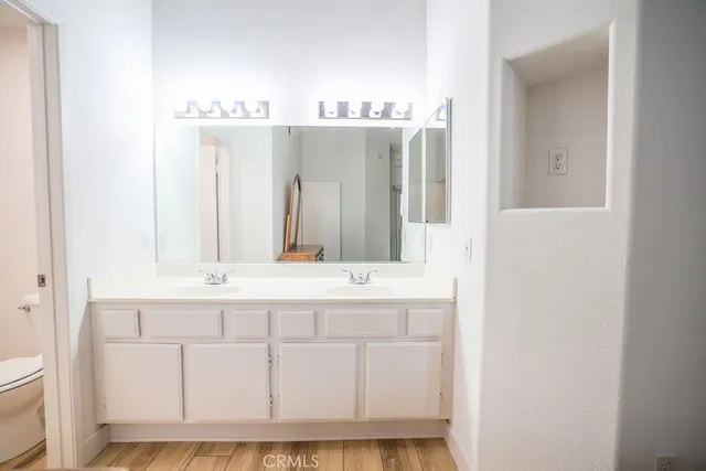 a bathroom with a sink vanity and mirror