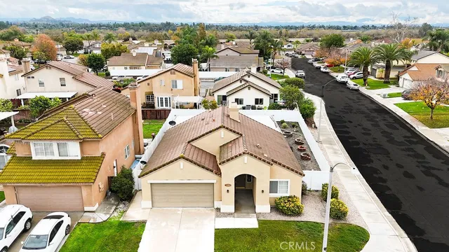 an aerial view of residential houses with outdoor space and ocean view